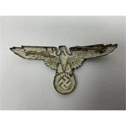 Five German 'SS' visor cap metal badges comprising one eagle and four skull and cross-bones (5)