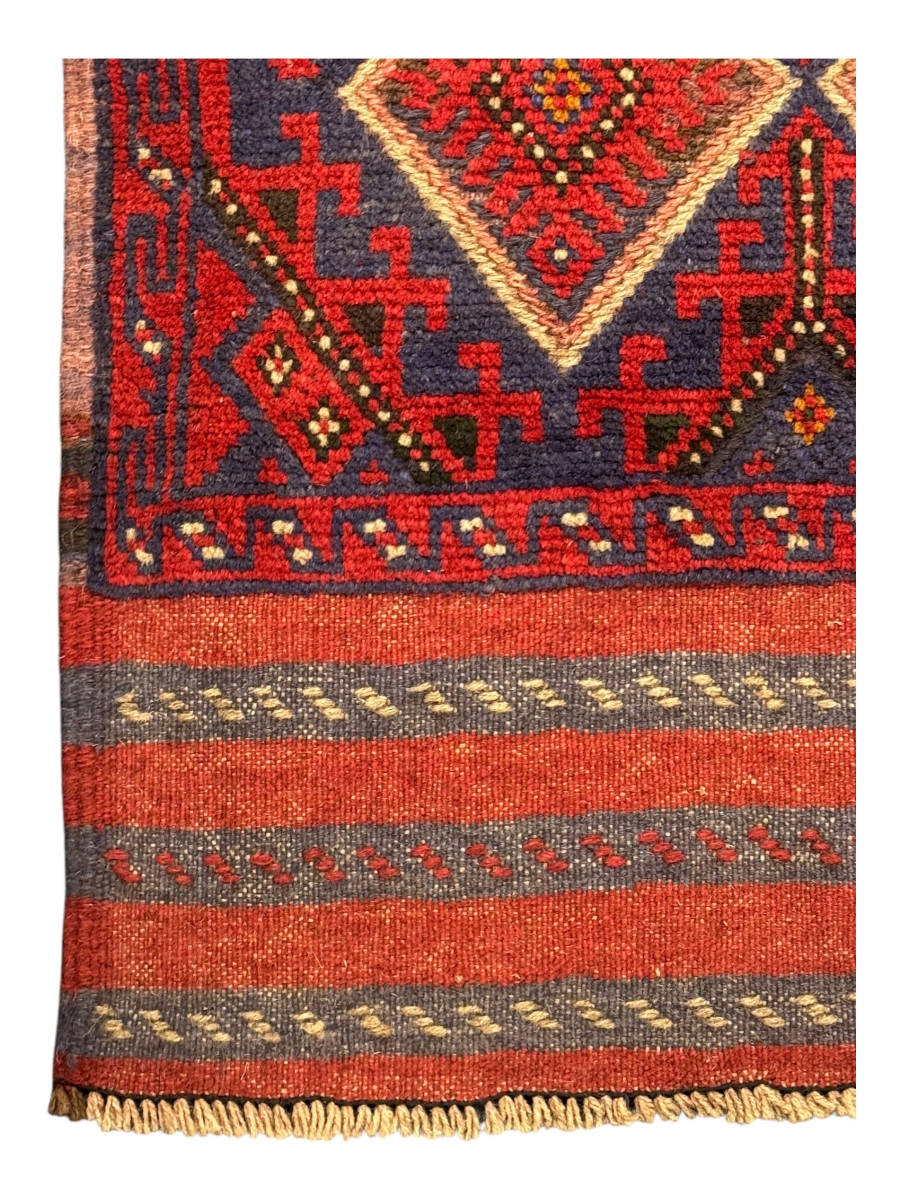 Pashtun Meshwani ground runner, central field decorated with rows of multicoloured diamond medallions, surrounded by geometric motifs, wide red and blue striped border with additional guard bands