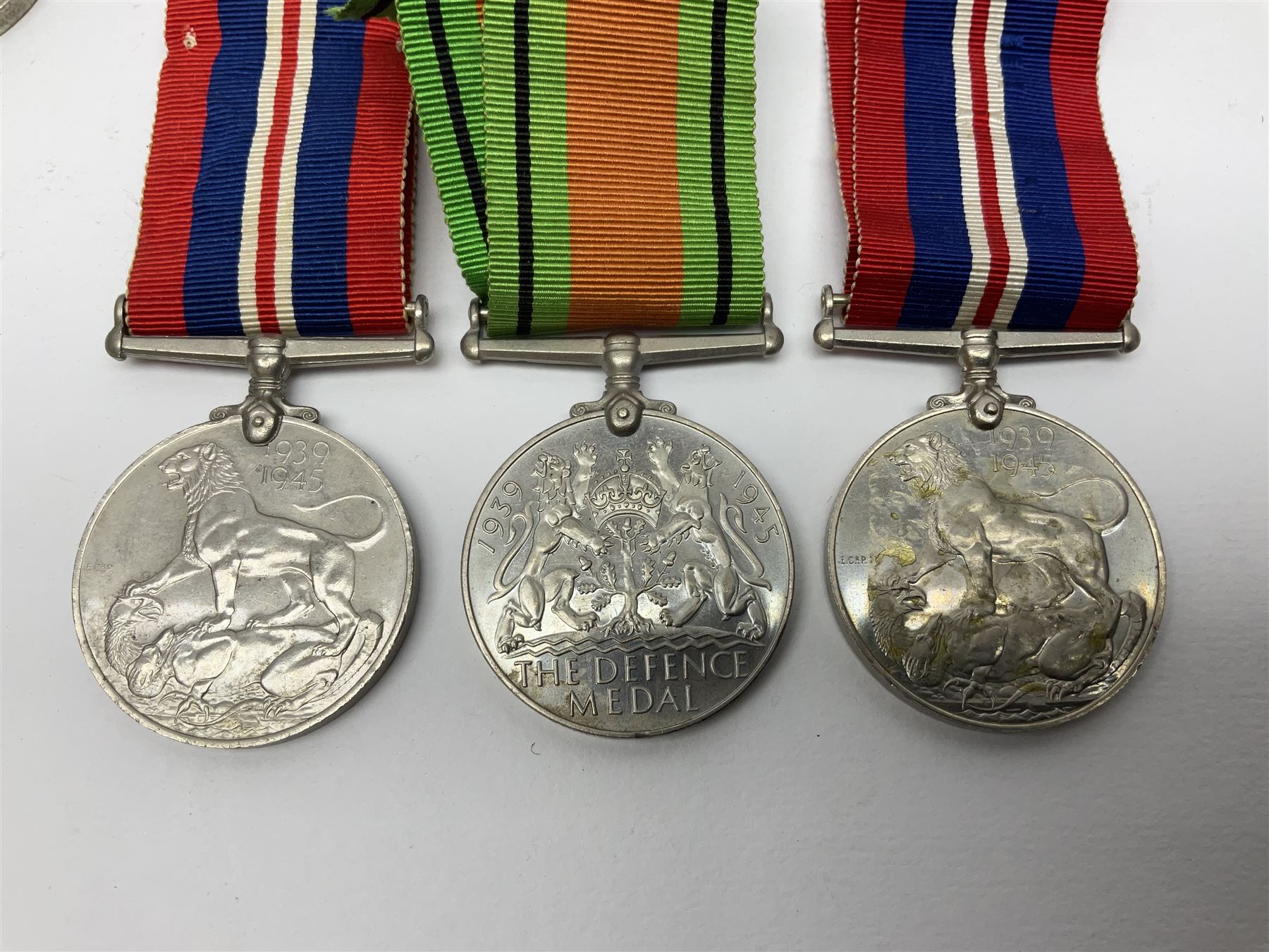Twelve WW2 medals comprising four 1939-1945 war medals, four Defence medals, three 1939-1945 Stars and Africa Star; all with ribbons; some as groups in two issue boxes with slips