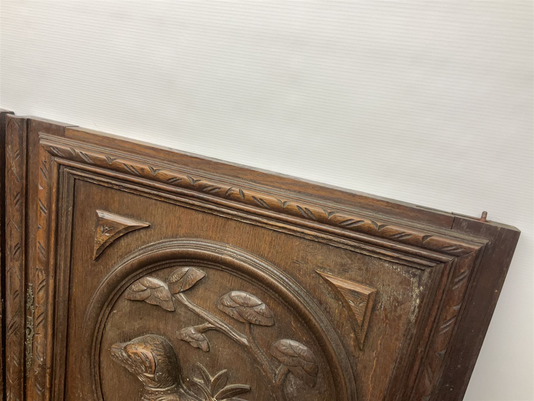 Pair of oak furniture door panels, carved in relief with a fox to one and a hound to the other, together with a pair of smaller oak panels, carved in relief with a hare to one and a grouse to the other, doors W63.cm x H62cm, panels W43cm x H60cm