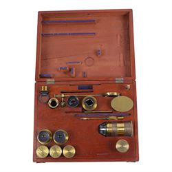 19th century brass binocular microscope by R&J Beck, 31 Cornhill London, numbered 6386, with rack and pinion focusing, housed in wooden case with case of accessories, including eyepieces, objective lenses and condenser