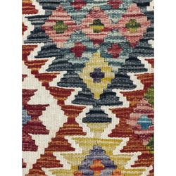 Chobi Kilim flatweave rug, cream ground with a multicoloured geometric diamond field, framed by a bold border of repeating stylised motifs, finished with braided corner tassels