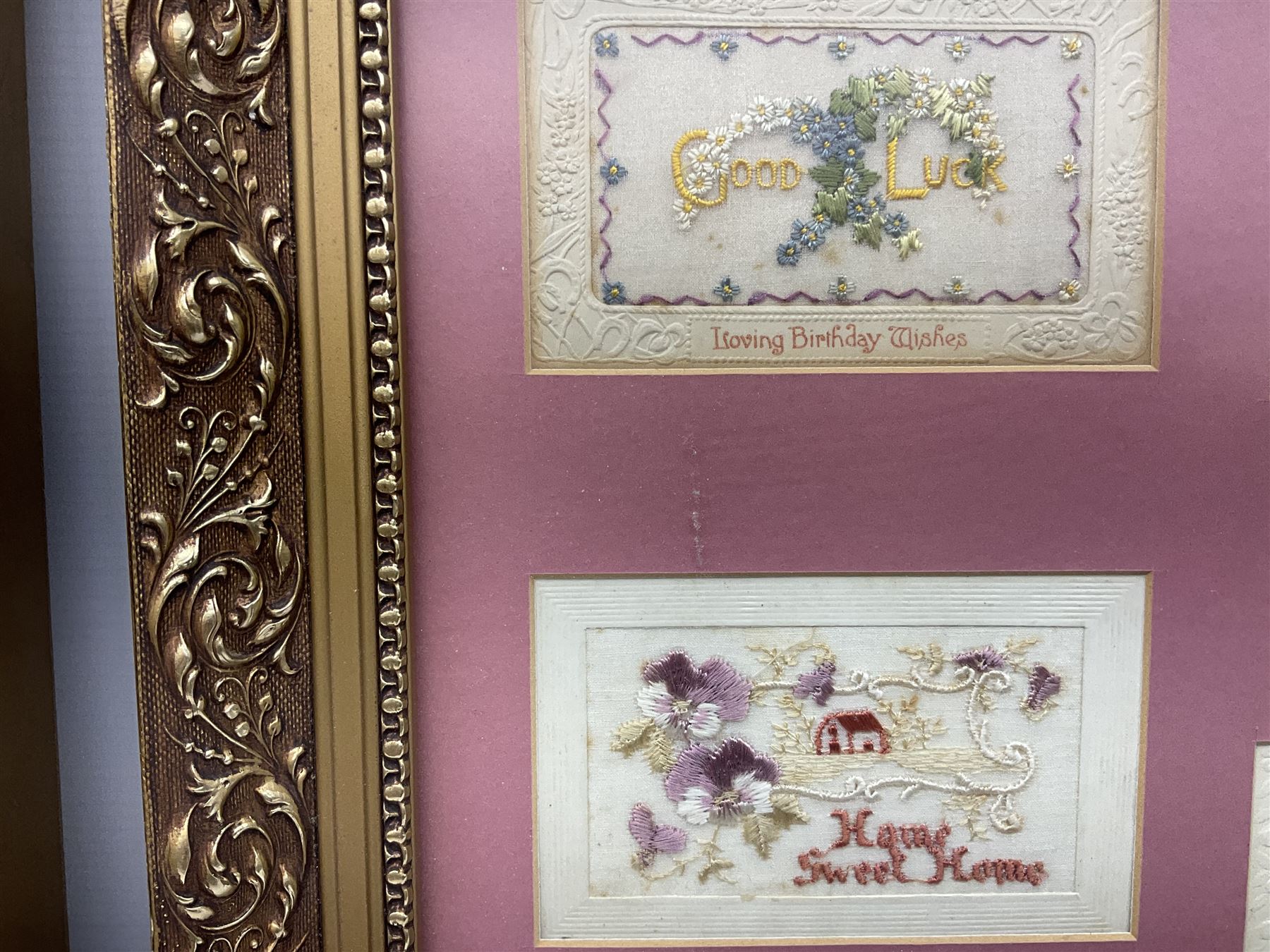 Thirty-five WW1 embroidered silk postcards including regimental crests, flags of the Allies, envelope type with greeting card inserts, Christmas and birthday cards etc; mounted and glazed in three graduated modern matching gilt frames (3)