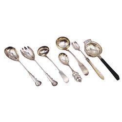 Group of silver, comprising pair of early 20th century salad servers, hallmarked Josiah Williams & Co, London 1915, George IV Fiddle pattern sauce ladle, hallmarked William Eaton, London 1829, Victorian salad fork with mother of pearl handle, hallmarked Atkin Brothers, Sheffield 1896, a Scandinavian silver caddy spoon, stamped NM 830, tea strainer with wooden handle and a toddy ladle, both unmarked 
