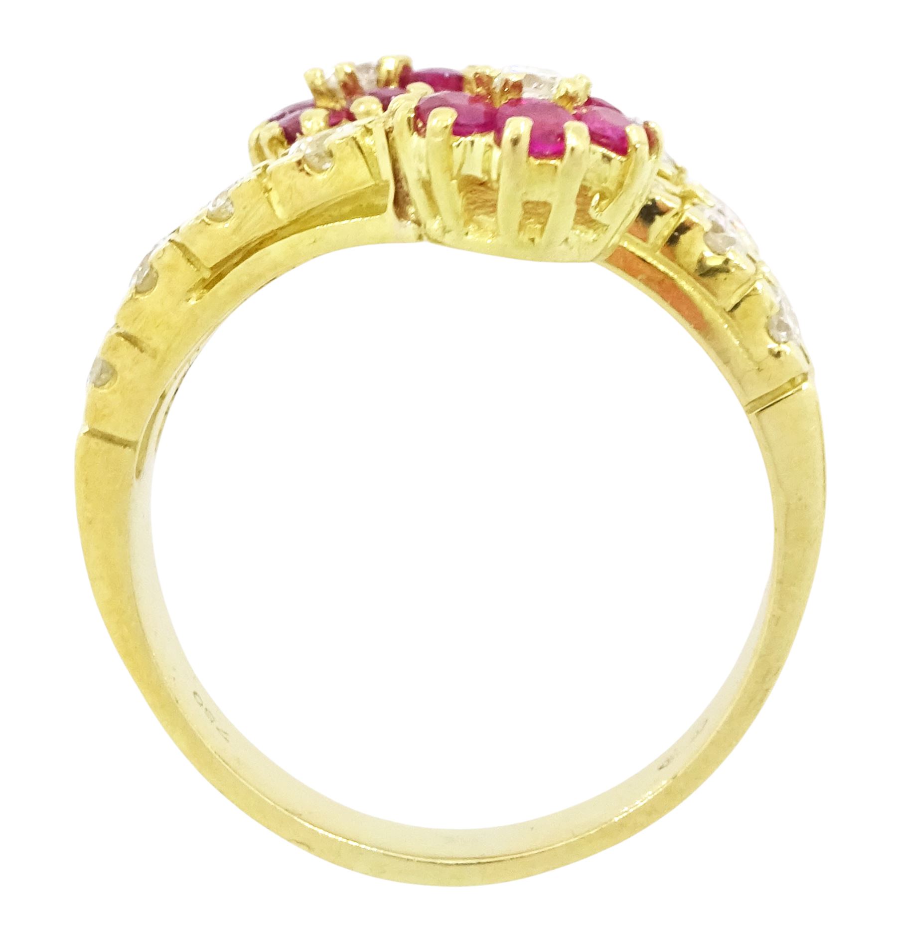 18ct gold ruby and diamond flower head crossover ring, two flowers each set with a single round brilliant cut diamond and six rubies, to diamond set stems and spaced by a row of nine diamonds, stamped 750, total diamond weight approx 0.55 carat
