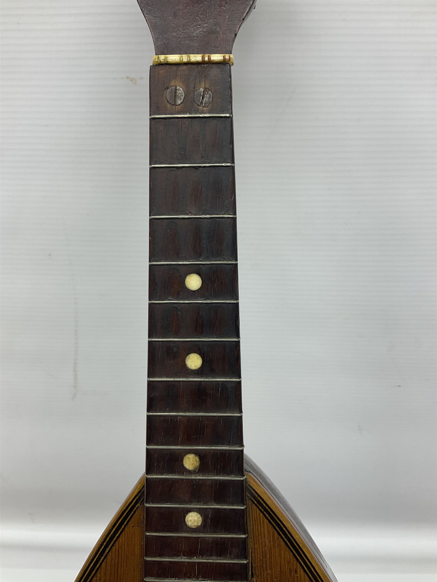Late 19th century Italian lute back mandolin with segmented bowl back, bears label Gennaro Maglioni Napoli L61cm; in ebonised wooden case; together with another similar damaged Italian lute back mandolin for restoration or spares (2)