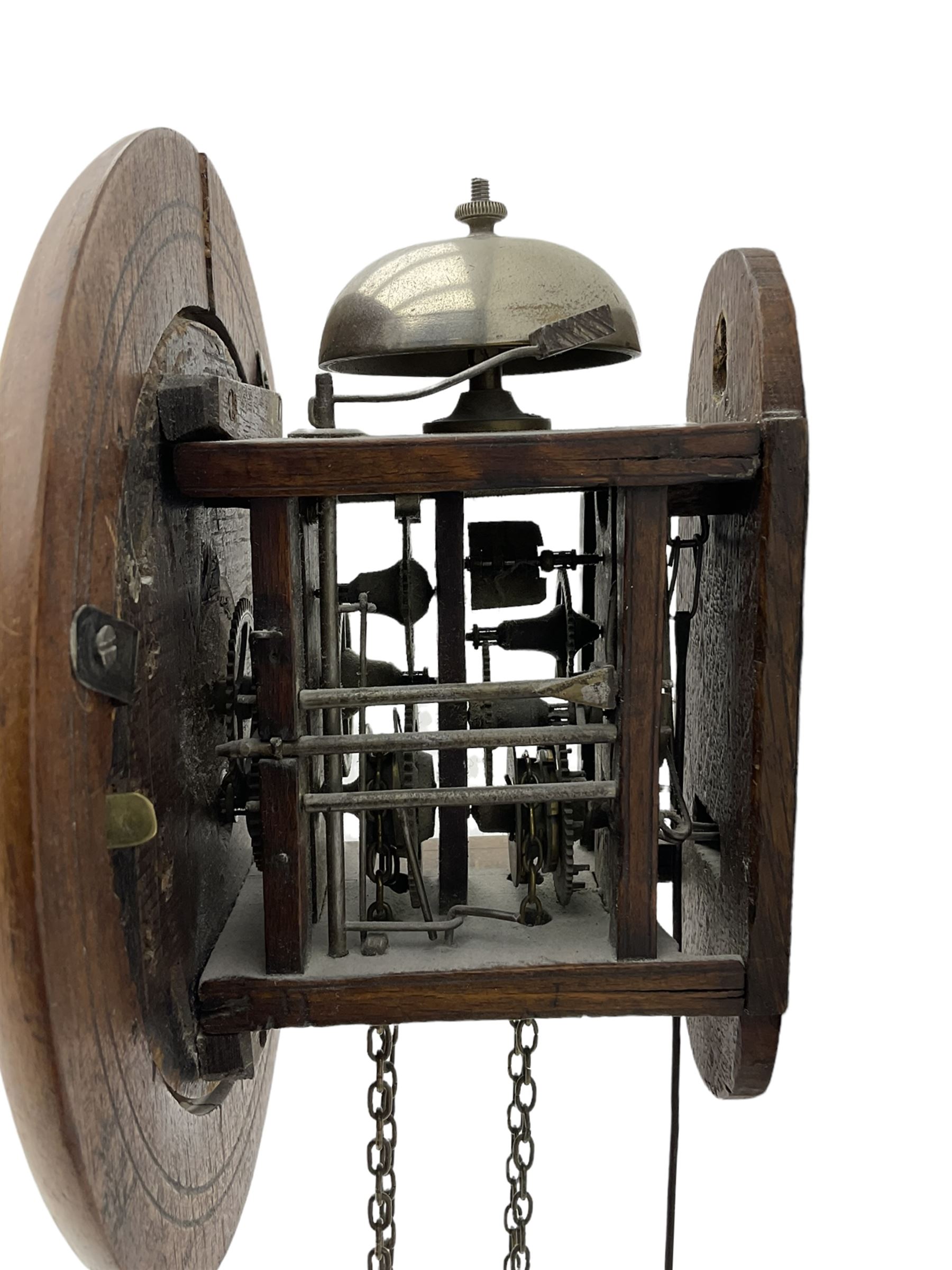 Small late 19th century German Bavarian wall clock c1880, 6” painted dial with Roman numerals, minute track and steel moon hands, cast brass bezel and flat glass with a mahogany surround, chain driven striking movement striking the hours on a bell, wooden plated movement with brass wheels and lantern pinions. With original pendulum and original weights.

