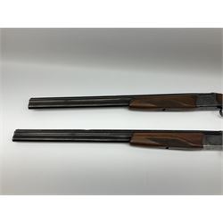 Two Russian Baikal 12-bore over-and-under double barrel boxlock non-ejector sporting guns; one with 68.5cm barrels, walnut stock with chequered pistol grip and fore-end and thumb safety, serial no.520545, L111cm overall; the other with 72.5cm barrels, walnut stock with chequered pistol grip and fore-end and thumb safety, serial no.012448, L114.5cm overall (2) SHOTGUN CERTIFICATE REQUIRED
