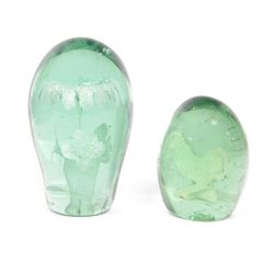 Two 19th century green glass dump paperweights, each of globular form, the smaller example...