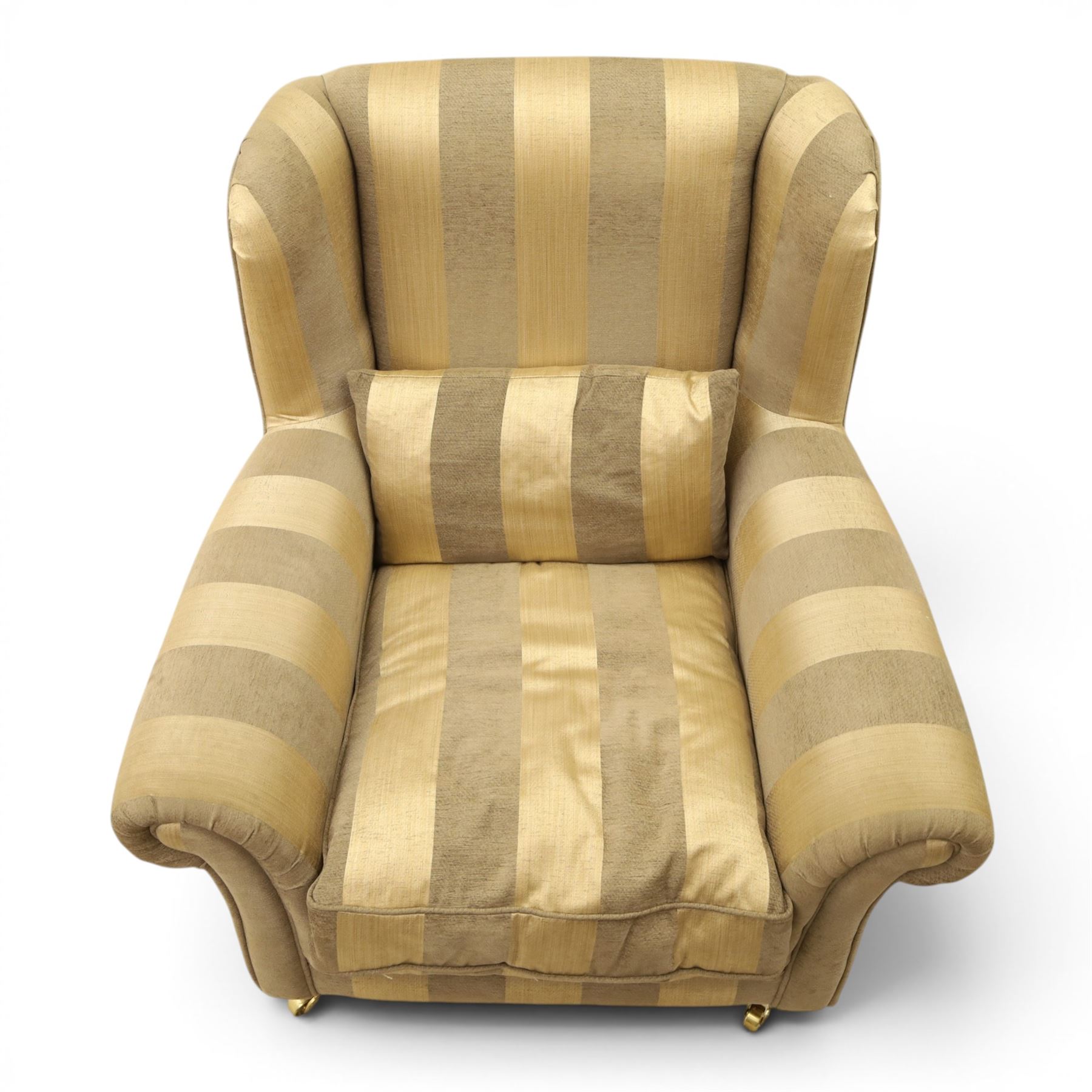 Alstons - 'Ixworth' armchair, upholstered in striped fabric, with loose seat cushions and scrolled arms, brass front castors