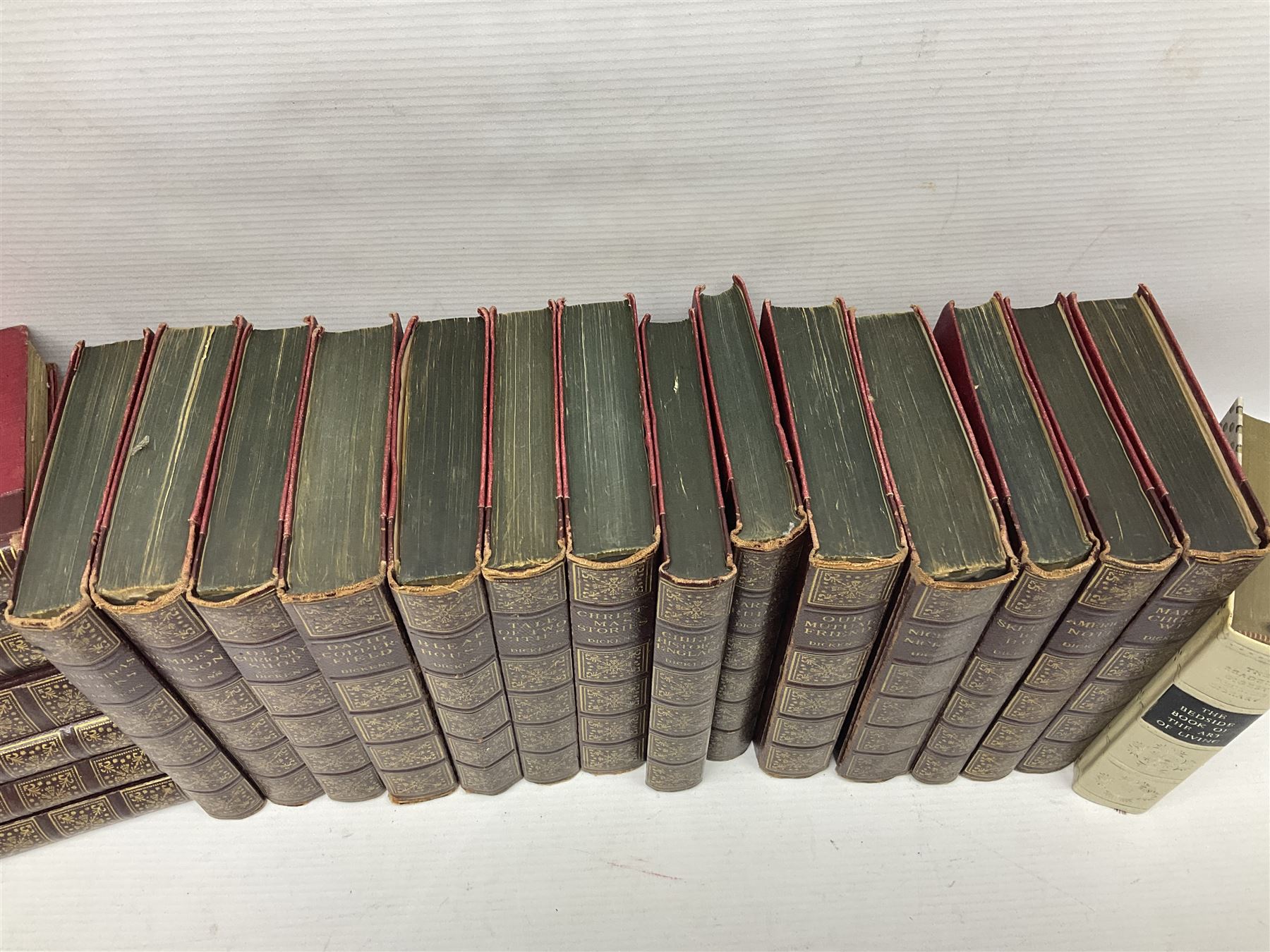 Twenty one volumes of Charles Dickens,  by The Home Library Book company, together with The Readers Digest bedside book of the art of living 