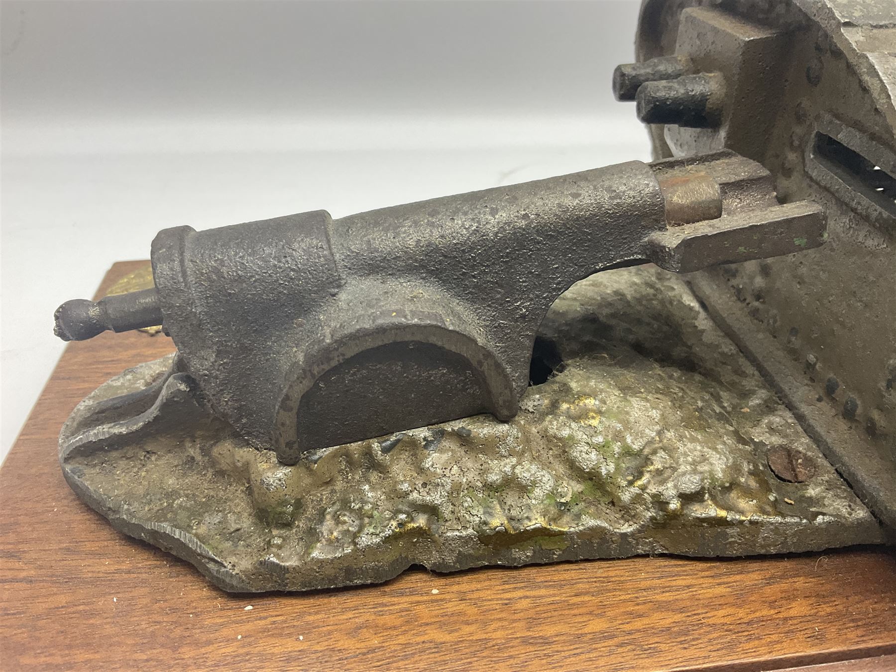 Early 20th century mechanical money bank 'Tank and Cannon' by Starkies, mounted on an oblong mahogany base with WW1 Tank Corps cap badge; patented 16th January 1919 L29.5cm