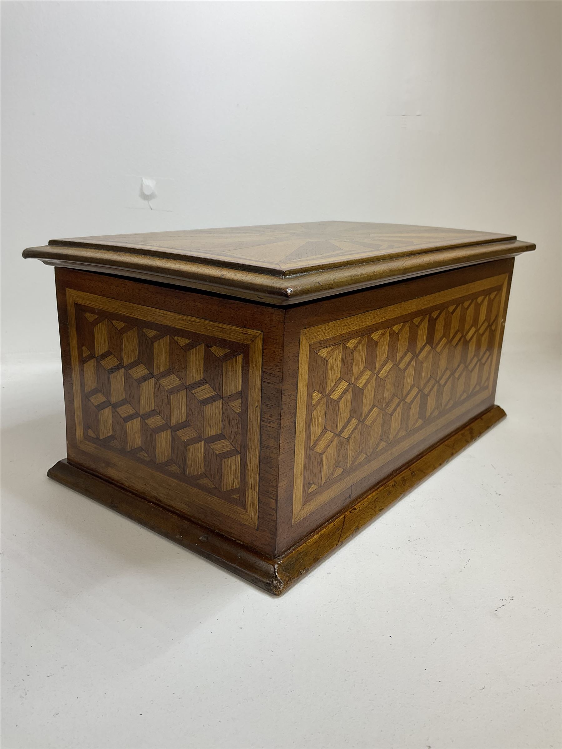 19th Century mahogany and parquetry box of rectangular form, geometric cube design, with a stylised sun detail to the hinged cover, opening to reveal three compartments, L33cm D21cm H16cm
