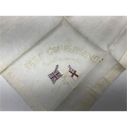 Three WW1 embroidered silk handkerchiefs including RAF & RN; trench art brass napkin ring inscribed 'Arras' and miniature peaked cap with inset 1914 penny; small quantity of cap badges and pips; four reference books on medals and badges etc
