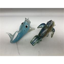 Two Murano stylised glass fish, each raised upon two clear fins, together with paperweight modelled as fish in a bag