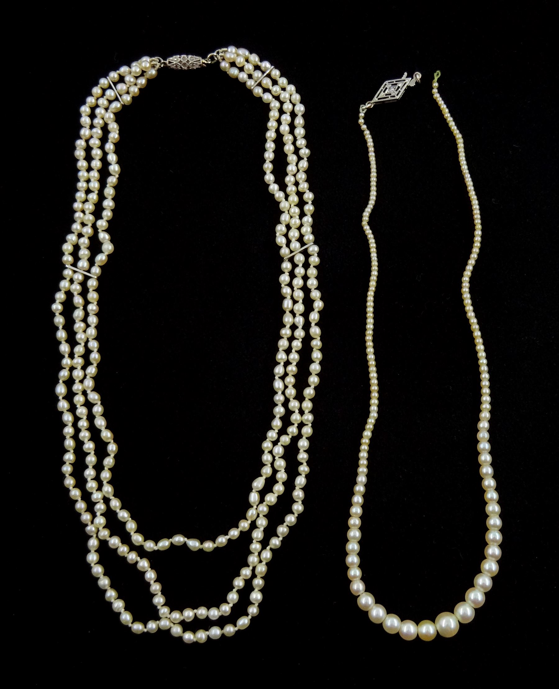 Three strand pearl necklace, with platinum diamond milgrain clasp and a single strand graduating pearl necklace with 18ct white gold clasp set with a diamond