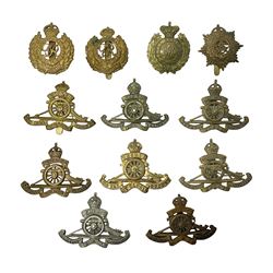 Twelve cap badges including Royal Artill