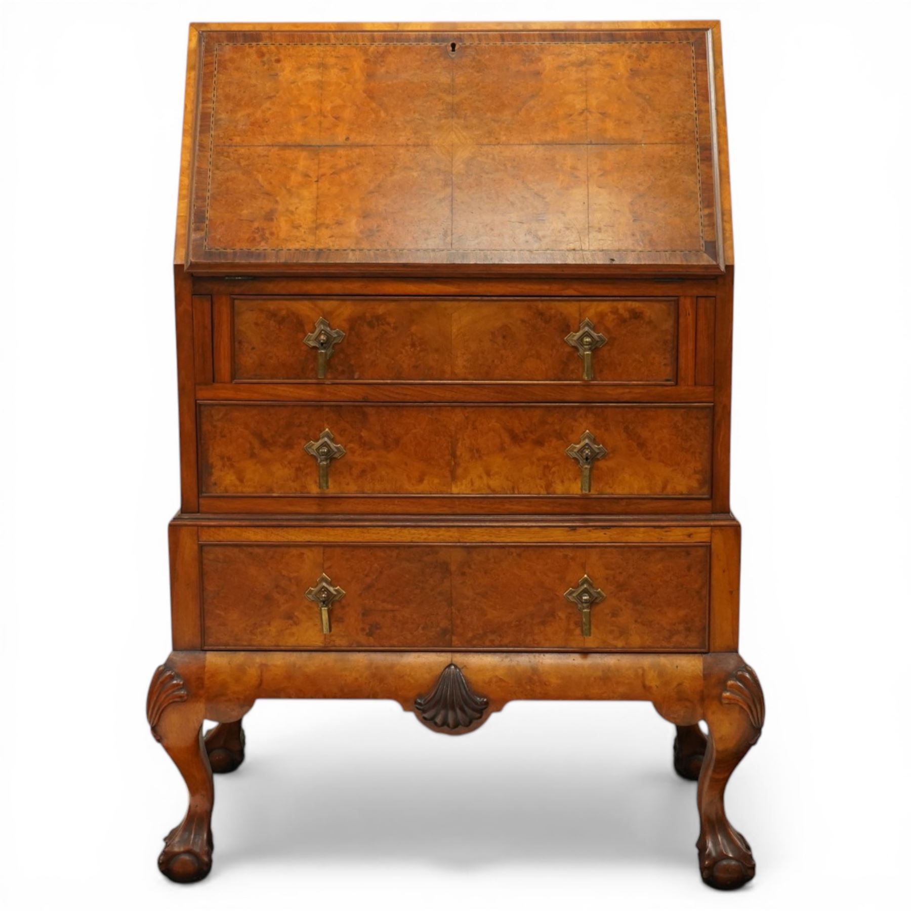 Early 20th century Queen Anne design figured walnut bureau, fall-front enclosing fitted interior, over three graduating cock-beaded drawers, shaped apron with moulded scallop shell motifs, over cabriole supports with ball-and-claw feet