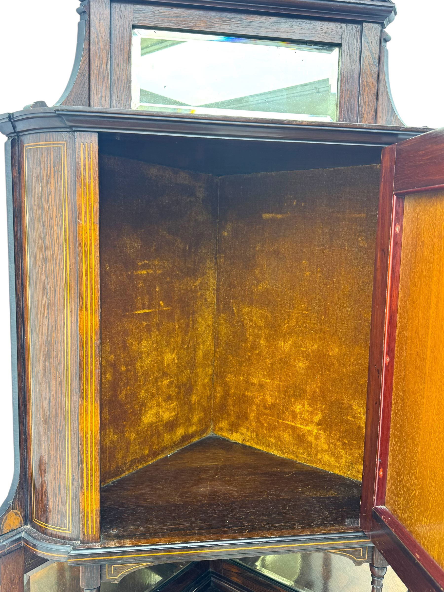 Late 19th century inlaid rosewood free standing corner display cabinet, the upper section featuring a mirrored panel above an inlaid cupboard with a felt-lined interior, complemented by a recessed open compartment with a mirrored back, the base with a glazed door enclosing two felt-lined shelves, on turned supports