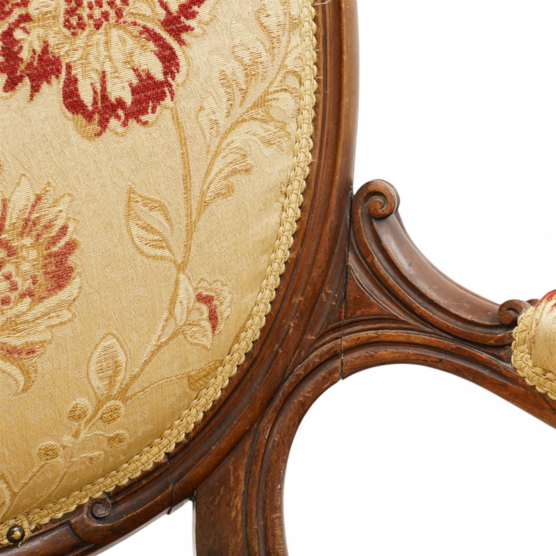 Victorian Ladies and Gentleman's carved walnut drawing room chairs, each with shaped cresting rail carved with scrolls and flowerheads, upholstered in pale gold floral fabric, raised on foliate-carved cabriole supports terminating to brass and ceramic castors