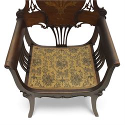 Art Nouveau mahogany open armchair in the manner of Shapland & Petter, the shaped and pierced back with foliate cresting and central panel inlaid with stylised marquetry plume, curved arms over upholstered seat, raised on sabre legs