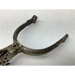 Pair of late 19th century South American iron spurs, engraved silver mounts, with sunburst rowls