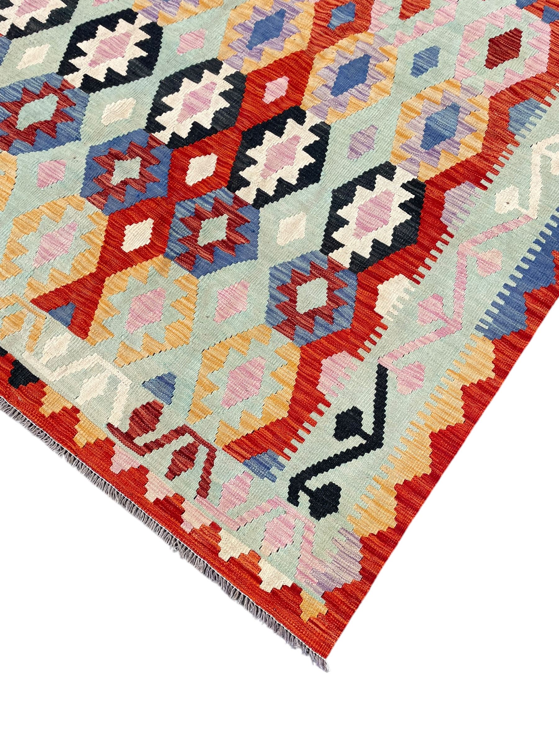 Large Kilim carpet, overall geometric design, decorated with lozenges within a tailing border, geometric guard stripes 