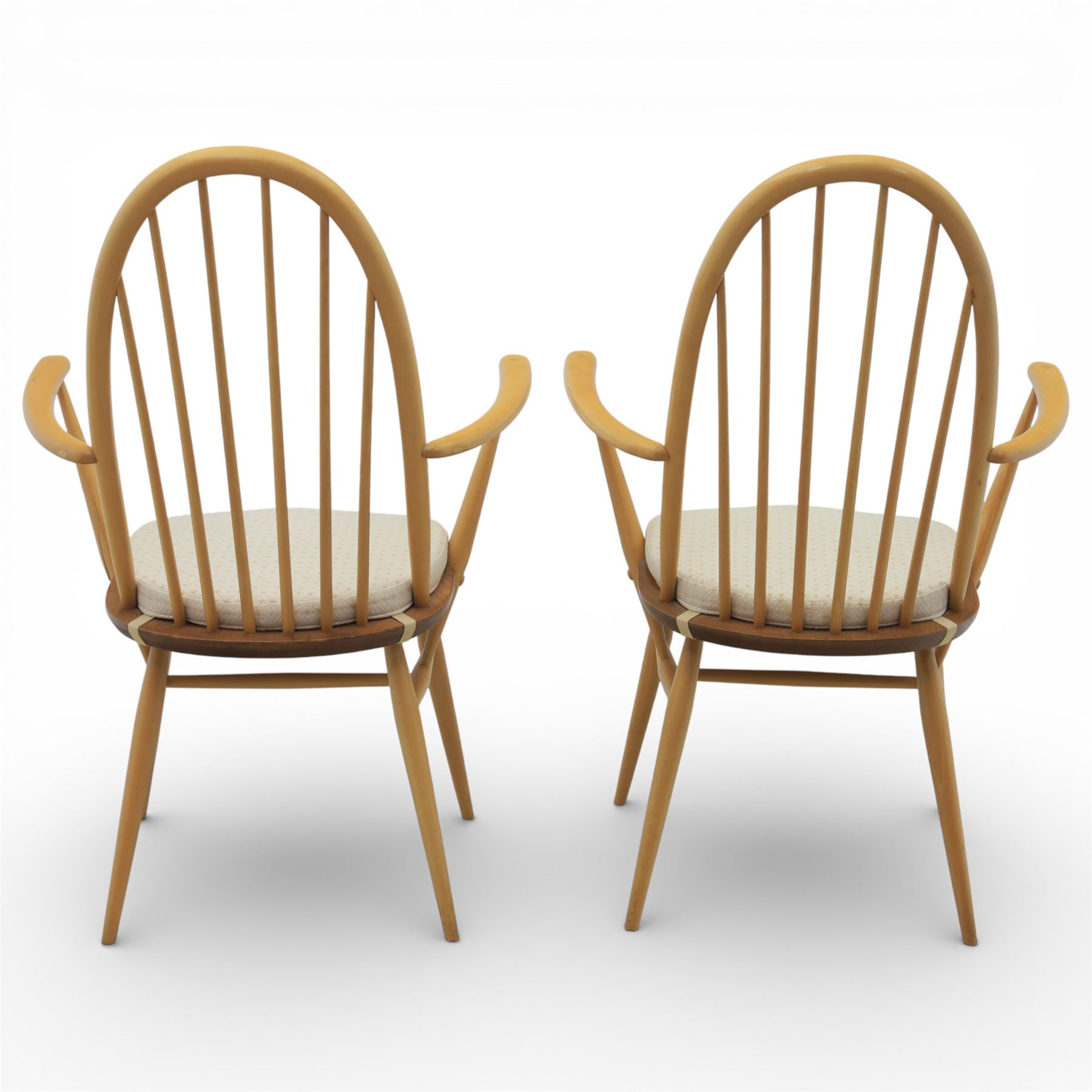 Ercol - elm dining chairs, set of six including two armchairs, arched spindle backs over shaped elm seats with upholstered pads, tapering beech legs joined by stretchers