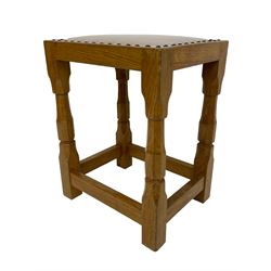 Brian Haw (former Mouseman carver) - Yorkshire oak stool, pale leather upholstered seat with stud band, on octagonal supports joined by plain stretchers