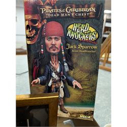 Collection of Disney and similar figures and memorabilia, including Pirates of the Caribbean Capt Jack Sparrow talking figure and NECA toys Jack Sparrow Head Knocker, three Disney showcase figures, Kermit the Frog framed film cell and Tomb Raider figure