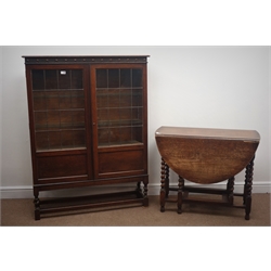  Early 20th century oak bookcase, carved frieze, two lead glazed doors enclosing three shelves, barley twist supports joined by stretchers (W107cm, H140cm, D31cm), and an oak drop leaf table  