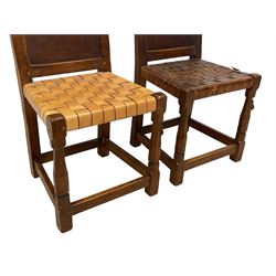 Mouseman - circa. 1930s set of six (4+2) oak dining chairs, panelled back carved with the Bagshawe family crest, the moto 'Forma Flos Fama Flatus' over an arm grasping a bugle-horn with ribbon tie and Yorkshire rose motif, adzed frame, leather lattice strap seat, on octagonal supports united by stretchers, two carvers and four side chairs, each carved with mouse signature, by Robert Thompson of Kilburn 

Provenance: Owned since manufacture by the Bagshawe family, descendants of the Staithes Group Artist Joseph Richard Bagshawe RBA (1870-1909).