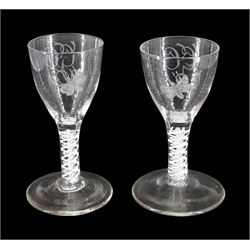 Pair of 18th century drinking glasses of possible Jacobite interest, the ogee bowls engraved with moth and initials 'G.G.', upon a double series opaque twist stems and conical feet, H12cm