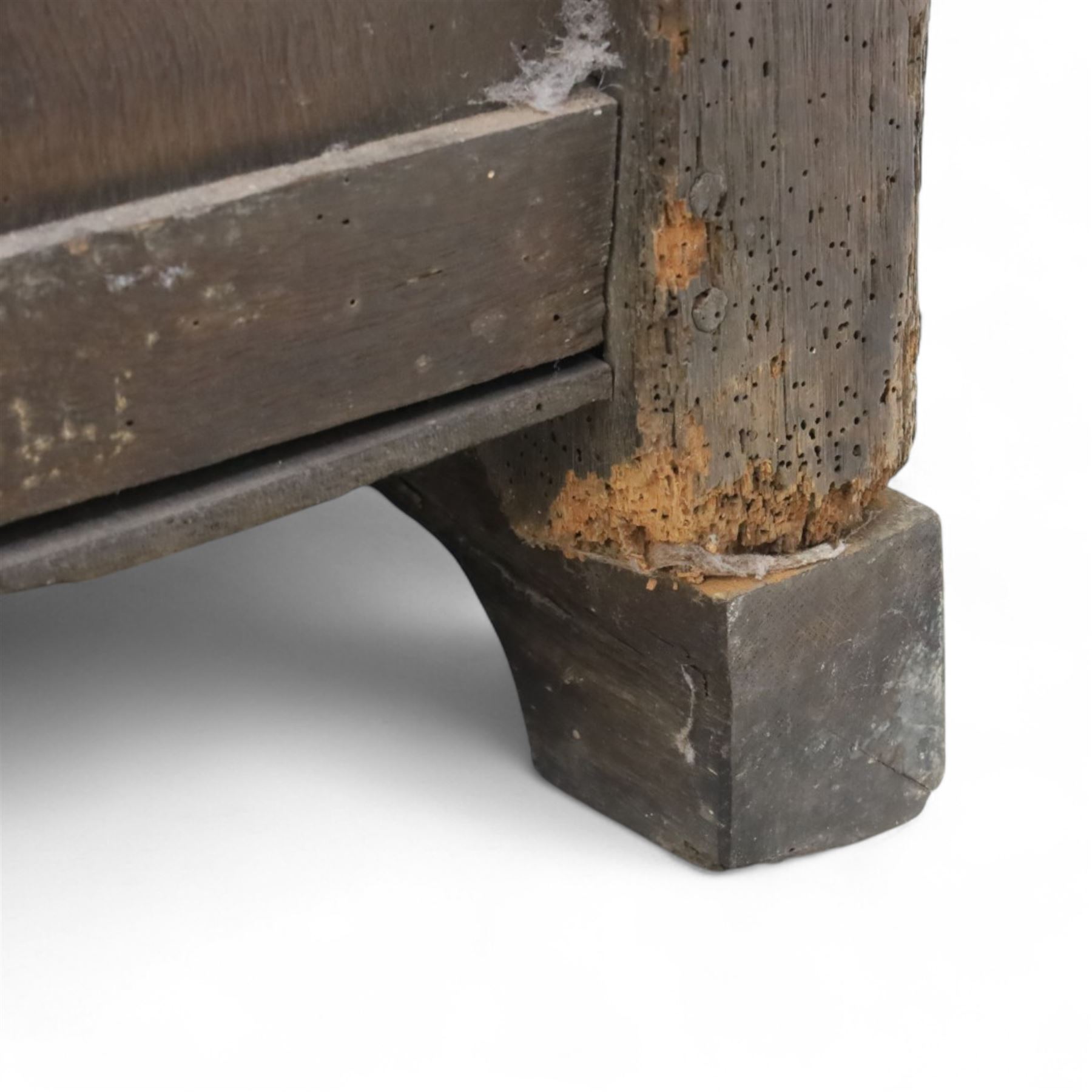 18th century oak five panel chest, with planked top with chamfered edges, hinged top enclosing two candle boxes, five fielded panels flanked by foliate carvings, raised on stile supports