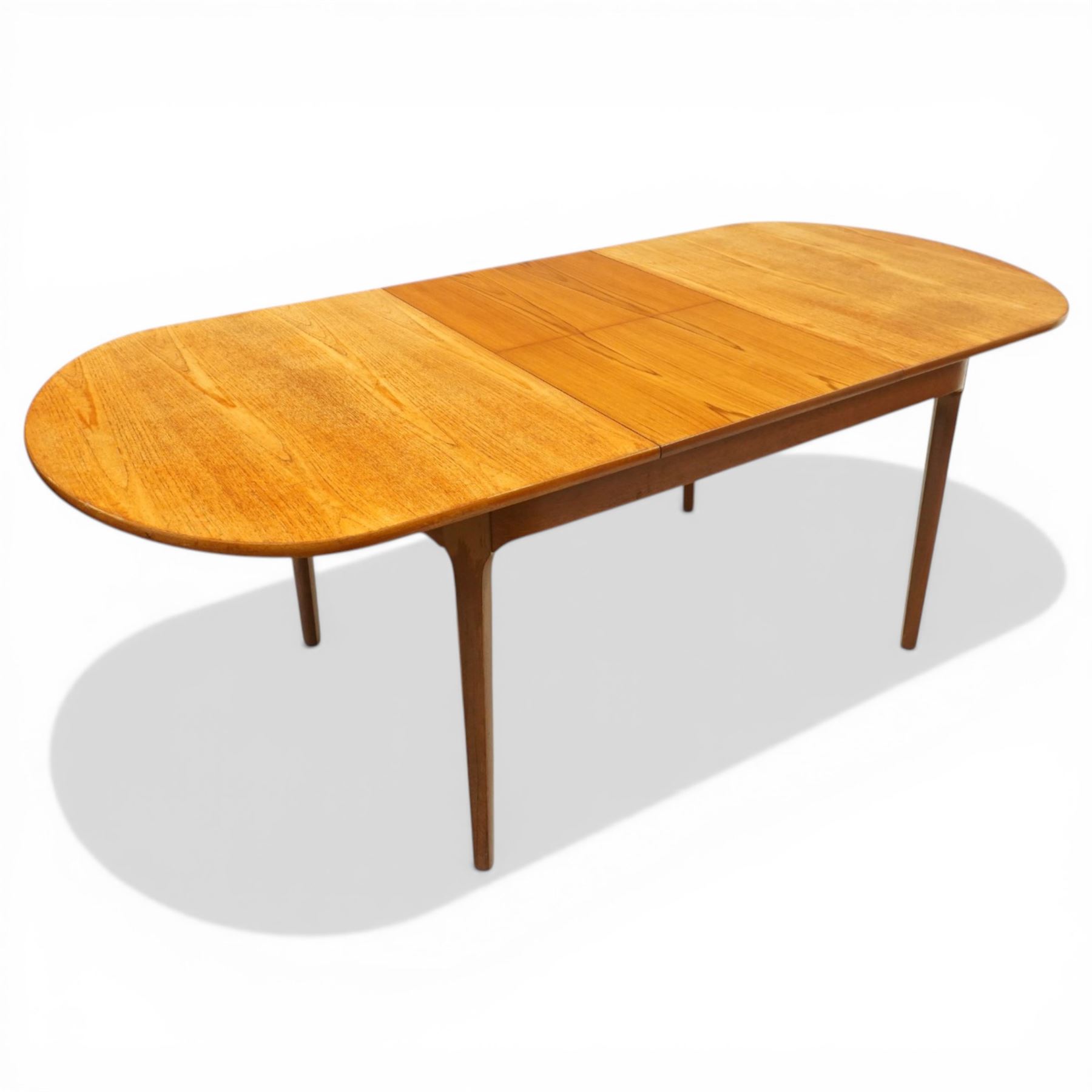 Nathan - teak oval extending dining table, together with set of eight matching low-back dining chairs with tan leather seats, extends to 203cm