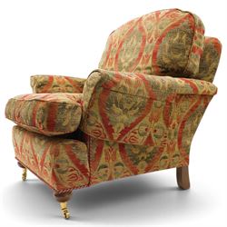 Duresta - traditional shape armchair with out-swept arms, upholstered in crimson ground fabric decorated with palmettes and foliate motifs with matching loose and scatter cushions, raised on compressed bun feet with brass cups and castors