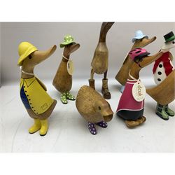 Quantity of the Duck Company UK DCUK carved bamboo root ducks, modelled wearing rain hats and rain boots etc, together with other similar carved wood ducks, tallest H26cm