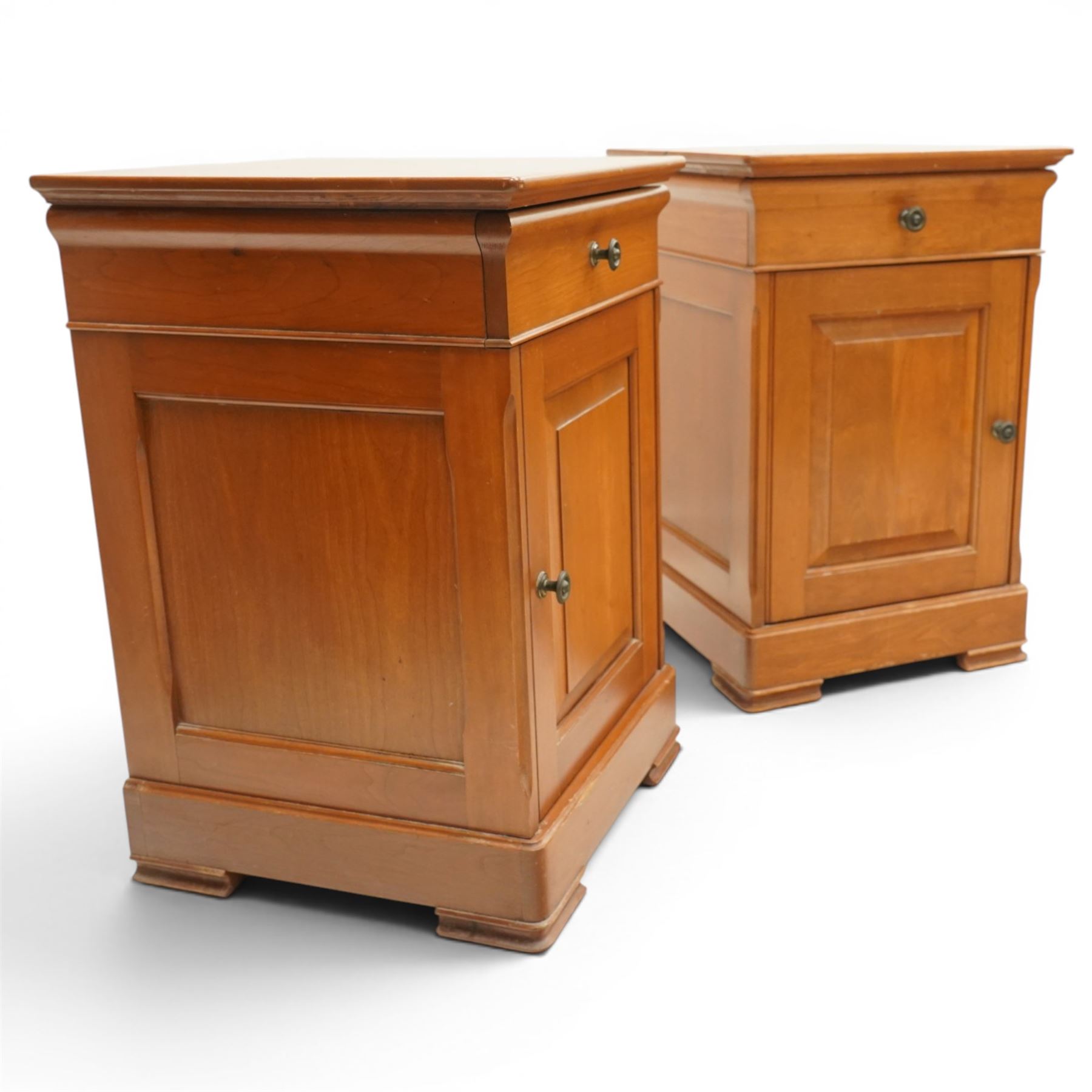 St Michael - pair of cherrywood bedside tables, single drawer above a fielded panel door, brass pulls, raised on a plinth base