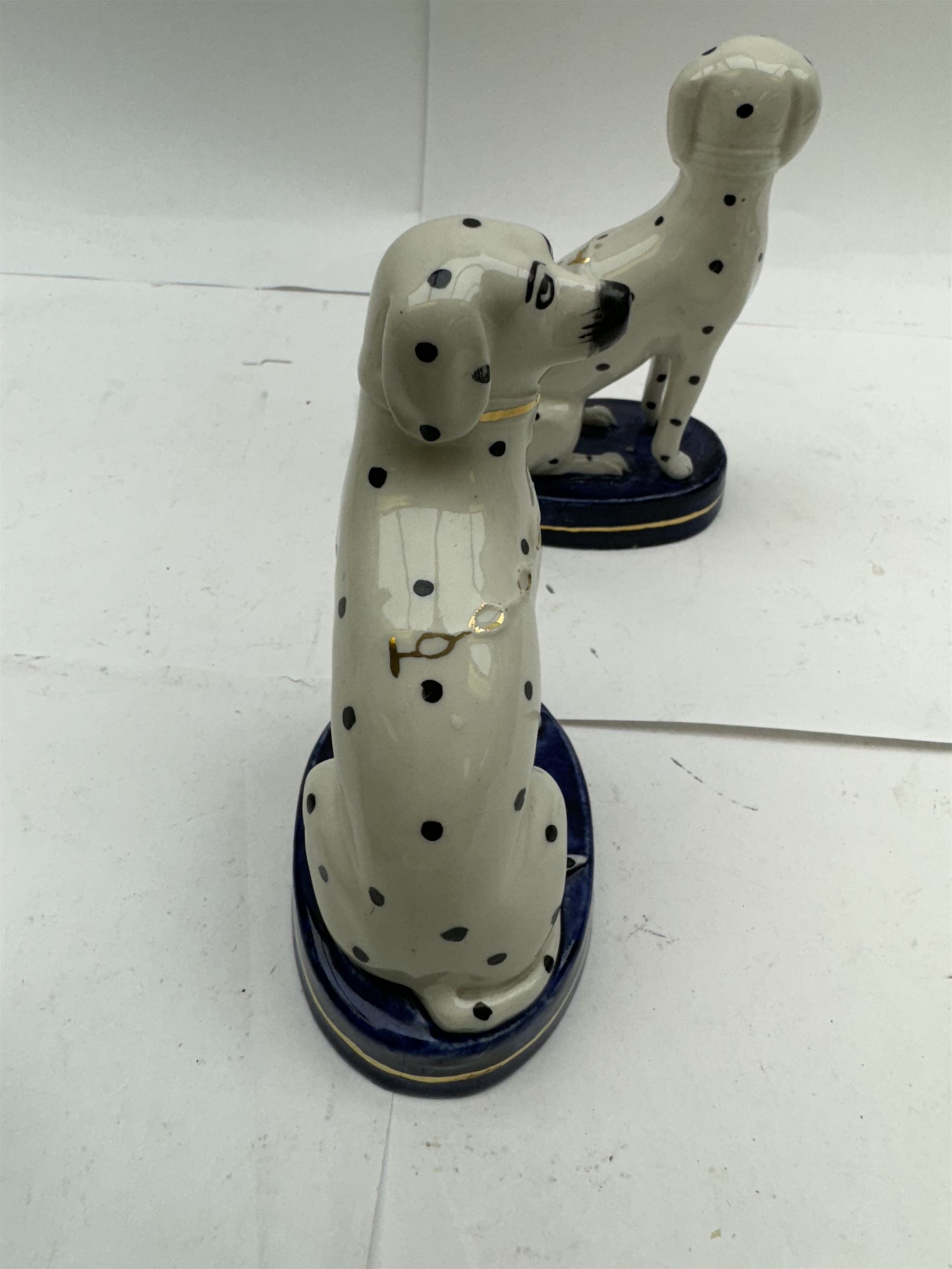 Pair of Staffordshire figures modelled as chained Dalmatians seated upon cobalt blue oval bases, H13cm, together with a Staffordshire pastille burner modelled as a castle, H12cm, a pair of 19th century Derby potpourri pots (lacking covers), and an 18th century blue and white tea bowl 