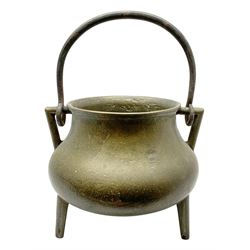 Bronze cauldron, probably late 17th century and Continental, of bellied form with twin angular handles supporting a further handle, upon three outswept feet, not including handle H23cm, rim D21cm