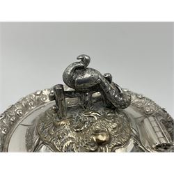 Victorian silver three piece tea service, comprising teapot, twin handled open sucrier, and milk jug, each of bellied form with acanthus capped scroll handles, the sides embossed with alternating scroll edged vacant panels and panels containing a pair of birds, upon four palmette feet, the teapot with ivory insulators to handle, and bird finial to the hinged domed cover, hallmarked William Hunter & Son, London 1861, teapot H19cm, including handles sucrier H13.5cm, including handle milk jug H12cm

This item has been registered for sale under Section 10 of the APHA Ivory Act