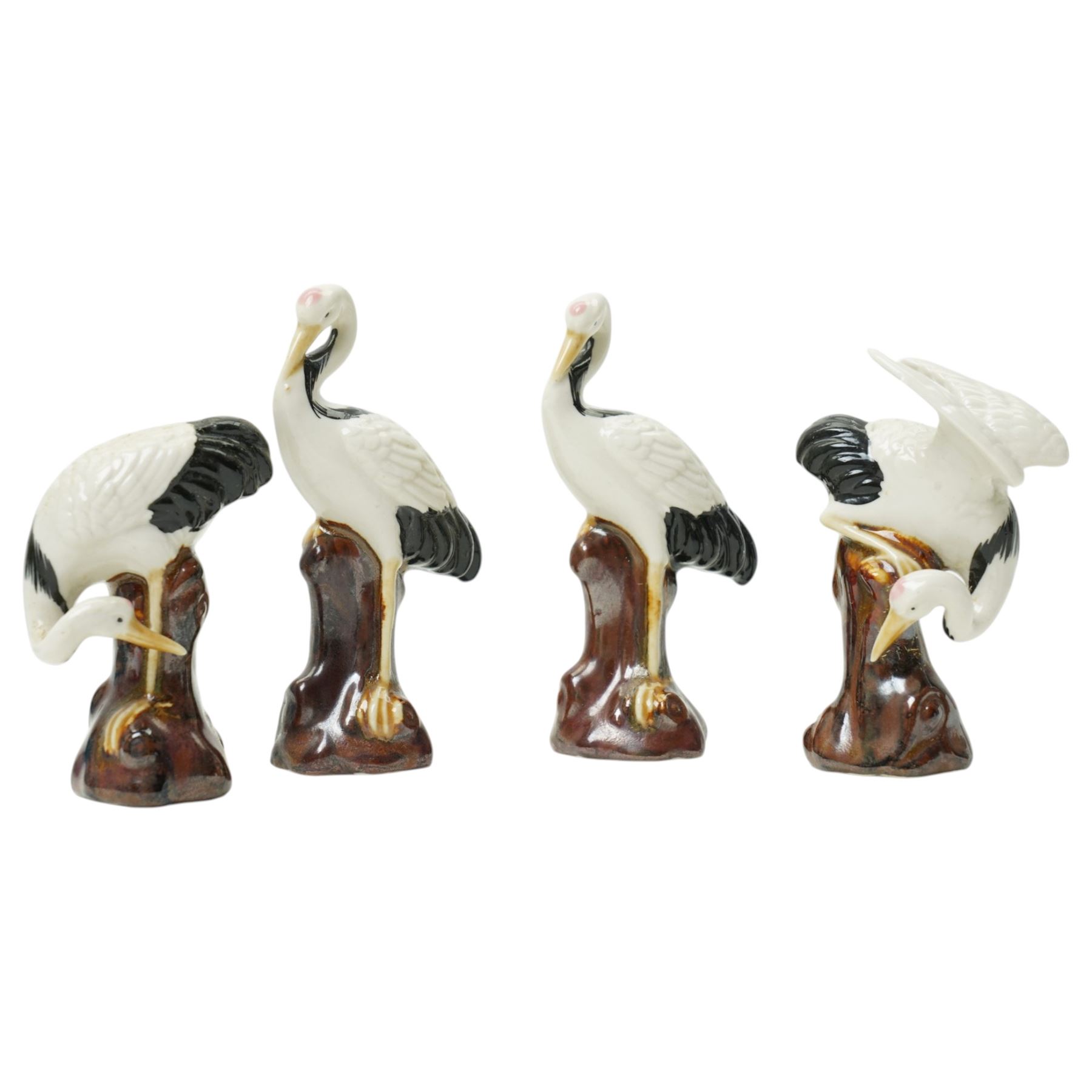 Pair of Chinese turquoise glazed phoenix figures, H20.5cm, together with a set of four crane figures perched upon stumps, H8.5cm (6)