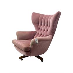 Paul Conti for G-Plan - 'Blofeld' Model 6250 swivel wingback armchair, upholstered in pink velour button back fabric, on teak base with castors