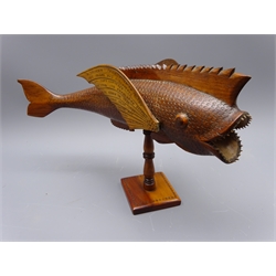  Pitcairn Islands carved wood model of a Fish inscribed 'A Souvenir From Pitcairn Island. This Island Was Discovered By Capt. Carteret In 1767. It's Population Started to Grow in 1790. This Year There Are 150 Inhabitants. Made By Bruce Young of Pitcairn A Descendant Descended From The H.M.S Bounty Mutineers Who Settled On This Remote Island In 1790, mounted on square stand, L44cm x H28cm   