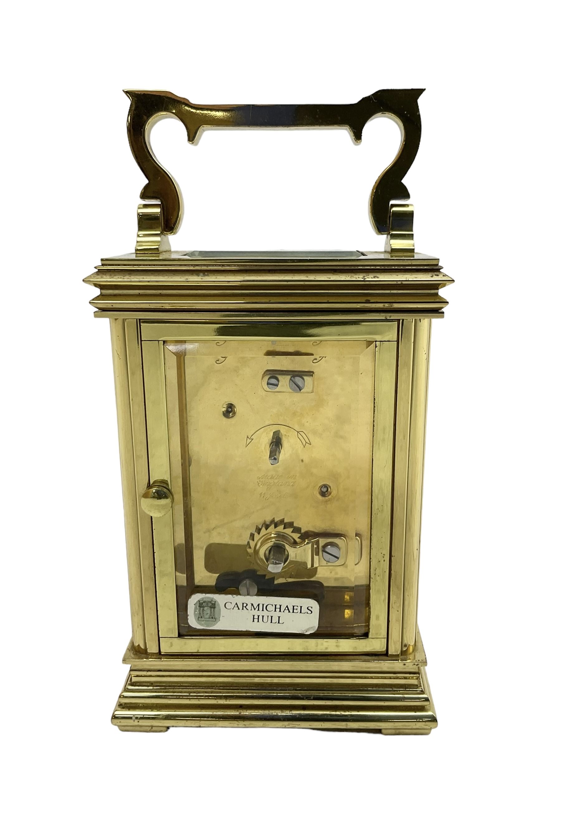 English - late 20th century 8-day carriage clock by Taylor & Bligh, in an Anglaise case with a rectangular handle, bevelled glass panels and enamel dial with Roman numerals, minute markers and steel moon hands, timepiece spring driven movement with a jewelled lever platform escapement. With key.