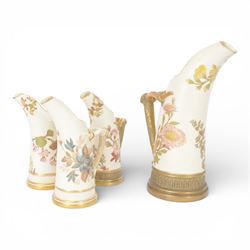 Four Royal Worcester tusk jugs of curved cylindrical form, the handle in the form of a gil...