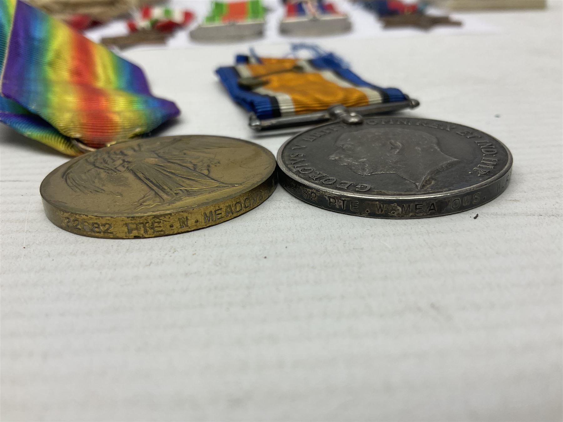 WWI pair of medals comprising British War Medal and Victory Medal awarded to 32682 Pte. W. Meadows W. Rid. R. in issue box; WWI pair of medals comprising 1914-15 Star and Victory Medal awarded to 3720 Pte. (later Cpl.) E. Petty W. York. R. with issue letter from Tank Corps; WWII group of five medals comprising 1939-45 War Medal, Defence Medal and 1939-45, Italy and Africa Stars; all with ribbons; and book of nineteen seaman's Certificates of Discharge to cook Charles Filburn 1893 - 1901 from various British ports