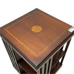 Edwardian revival inlaid mahogany revolving bookcase, square form with moulded top inlaid with central fan motif, two-tiers with moulded upright rails, on castors 