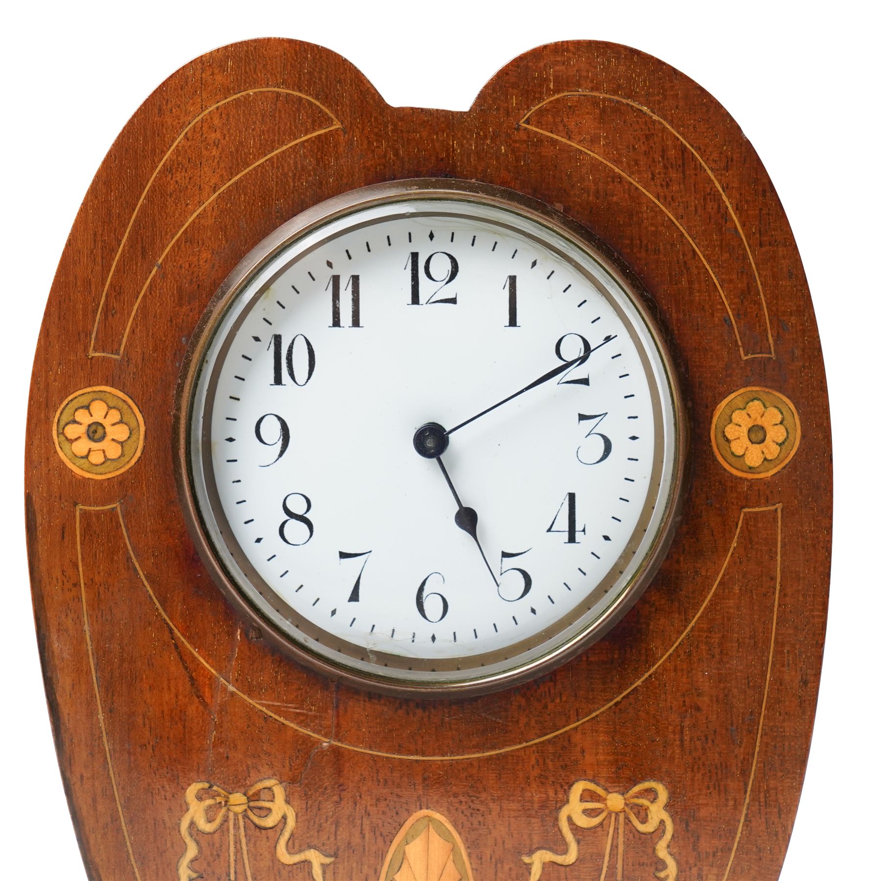 Edwardian- 8-day heart-shaped mahogany bedside table clock with decorative contrasting inlay c1905, white enamel dial with Arabic numerals, minute markers and steel spade hands, French timepiece movement with a later replacement lever platform escapement, wound and set from the rear. With key. 