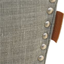 Neptune traditional style two-seat sofa, sloped back rest, gently flared arms, studded upholstered in a light grey fabric on square tapered legs 